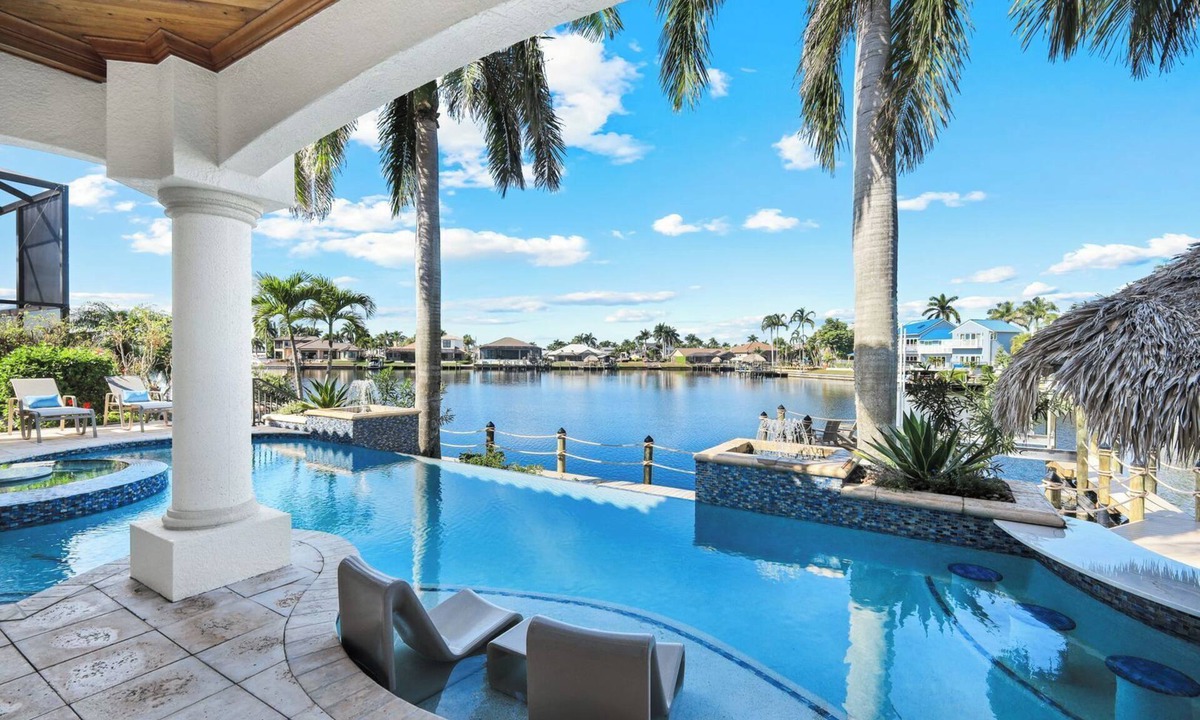 Pelican House | Paradise Palms Retreat - 5 BR (Sleeps 13) All New - Pool, Dock, Theatre + Games