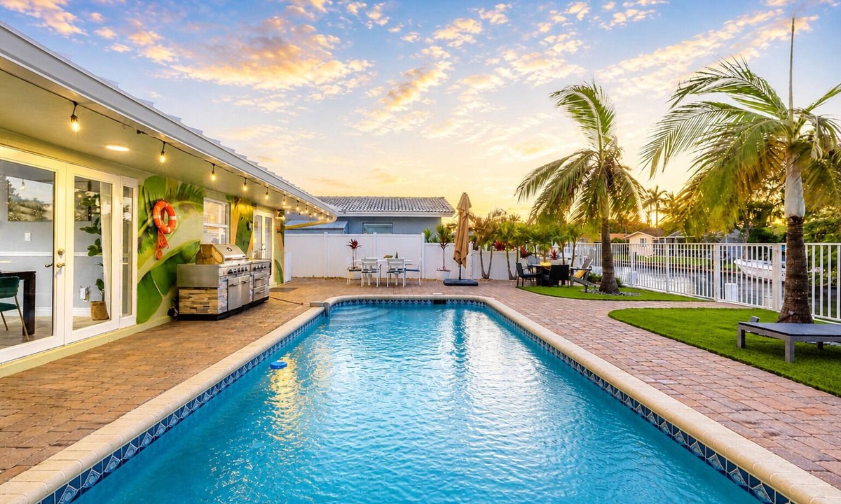 Coral Ridge Isles House | Pool Game Room Outdoor Lounge Private Dock Tiki Hut | Hummingbird Harbor