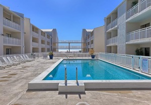 Cozy Beach Condo with Private Beach, heated pool, High Speed WiFi, and More.