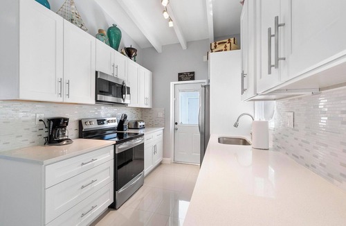 Dolphin Isles Apartment | Chic Modern Oasis with Pool – Steps from the Shore