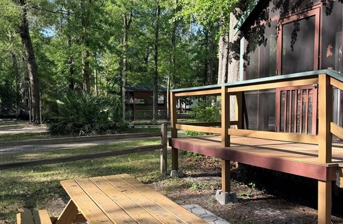 Folkston Cabin | Deluxe Cabin - The Bear Den - Our Deluxe Cabins offer comfort with a true Okefenokee feel. Climate controlled, private, and set in a quiet part of the campground.