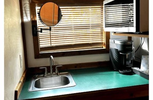 Folkston Cabin | Deluxe Cabin - The Gator Hole - Our Deluxe Cabins offer comfort with a true Okefenokee feel. Climate controlled, private, and set in a quiet part of the campground.