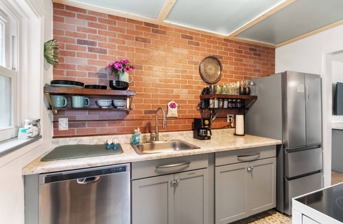 Warrington House | Discover this stunning, cozy retreat. Features a spacious, dedicated home office with curated books and games, a beautifully furnished living room, and stylish, thoughtful details. Perfect for a relaxing and productive stay.