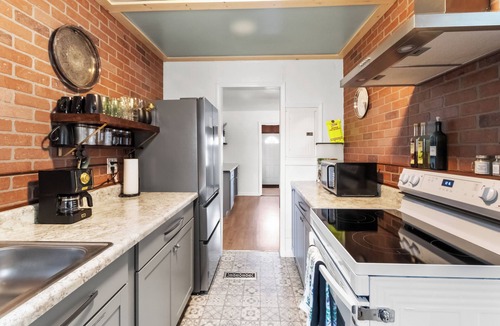Warrington House | Discover this stunning, cozy retreat. Features a spacious, dedicated home office with curated books and games, a beautifully furnished living room, and stylish, thoughtful details. Perfect for a relaxing and productive stay.