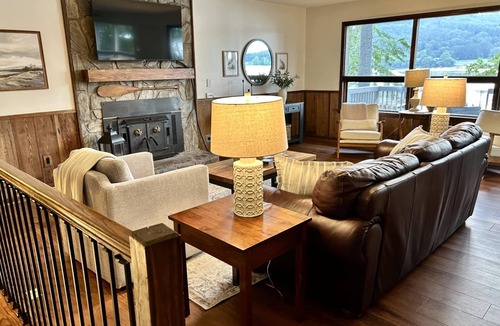 Grant House | Escape to our beautifully updated lakeside retreat, where every detail is designed for comfort and relaxation. From the moment you step inside this 3 bed/2bath house, you'll be captivated by sweeping, unobstructed views of the lake through expansive