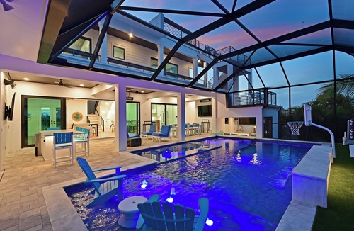 Whitney Beach House | Luxe Waterfront Canal Home w Heated Pool & Spa Rooftop Deck Outdoor Kitchen Golf