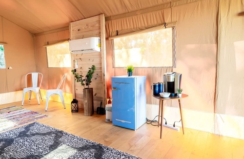 Braden River RV Rental | Luxurious Deluxe Safari Tent with King Bed and Outdoor Fire Pit in Bradenton, Florida