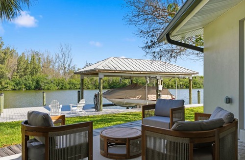 Cocoa Isles House | Luxury Waterfront Retreat Bikes, Hot Tub, Kayak, Walk to downtown Cocoa Beach.