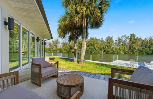 Cocoa Isles House | Luxury Waterfront Retreat Bikes, Hot Tub, Kayak, Walk to downtown Cocoa Beach.