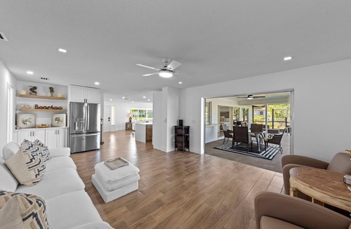 Town and River House | Modern riverfront home 4 br & 3 bath with stunning canal water views, private heated pool, garage & private dock access great for fishing, 4 bikes to explore, and minutes to Sanibel, Captiva, and local beaches.