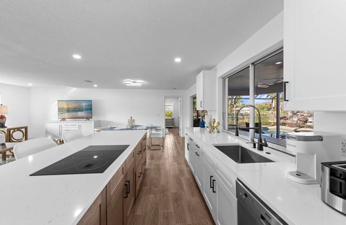 Town and River House | Modern riverfront home 4 br & 3 bath with stunning canal water views, private heated pool, garage & private dock access great for fishing, 4 bikes to explore, and minutes to Sanibel, Captiva, and local beaches.