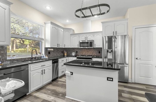 Port Richey House | Modern Spacious Getaway: Heated Pool, Movie Room, Huge Yard & Event-Friendly in New Port Richey, Florida