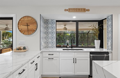 Shell Harbor House | Nestled along a pristine canal with long range views, this meticulously crafted residence defines coastal luxury at its finest.NEW!