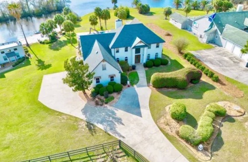 Douglas House | Resort style 5-bedroom lake house with white sand beach, pool, and pool house.