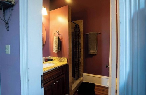 Treme Bed & Breakfast | Settle into a spacious private king suite with an en-suite bath and large private balcony in our historic boutique guesthouse. Enjoy shared living spaces, lush tropical gardens and a heated saltwater pool, just one mile from the French Quarter.