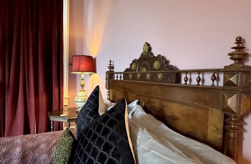 Treme Bed & Breakfast | Settle into a spacious private king suite with an en-suite bath and large private balcony in our historic boutique guesthouse. Enjoy shared living spaces, lush tropical gardens and a heated saltwater pool, just one mile from the French Quarter.