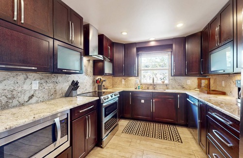 Cocoa Isles House | Tropical home with pool, lovely patio & game room - walk to beach