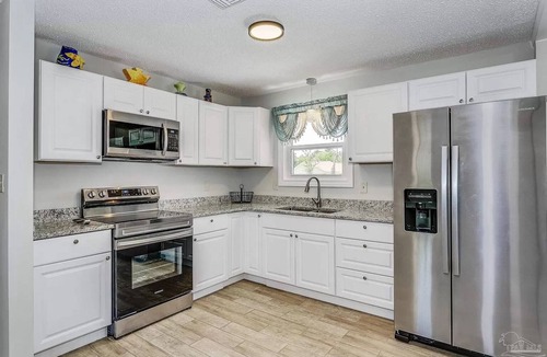 Myrtle Grove House | Very Private Home w/HEATED Pool, Palm Trees and Big Fenced Yard.