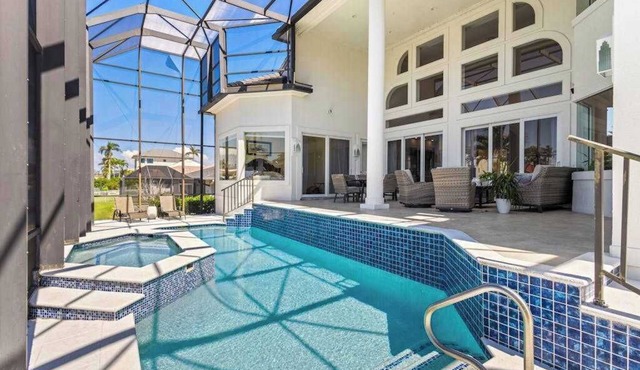 Exquisite waterfront home with lanai, heated pool and spa(hot tub), and internet