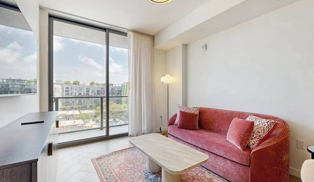 Modern condo with skyline views, rooftop pool & private balcony