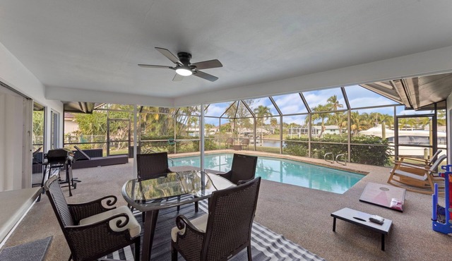 Modern riverfront home 4 br & 3 bath with stunning canal water views, private heated pool, garage & private dock access great for fishing, 4 bikes to explore, and minutes to Sanibel, Captiva, and local beaches.