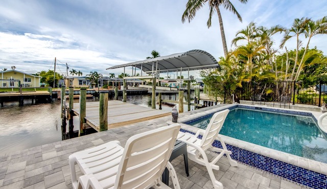 Tropical Oasis Pool Kayak Bikes fish from dock