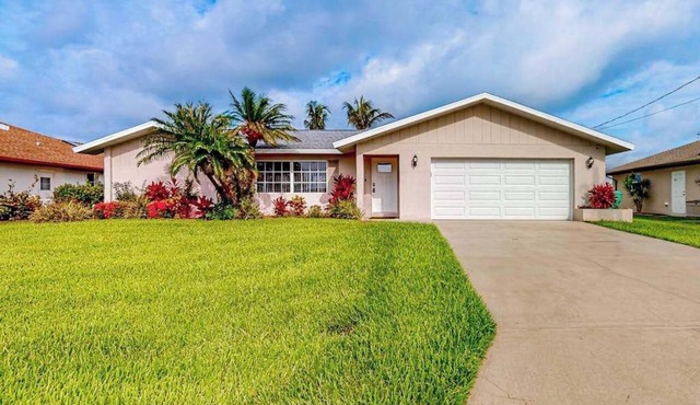 Waterfront home with an enclosed pool, outdoor kitchen, and grill - dog-friendly