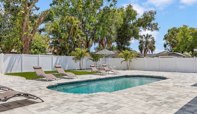 Welcome to Tropical Breeze Oasis w/heated pool and relaxing back yard & patio