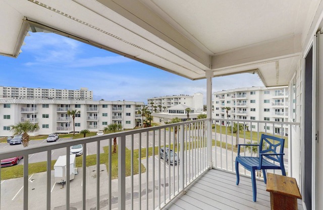 Casual condo steps from the beach with AC, balcony, resort pools, & free WiFi