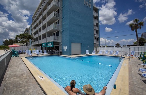 Treasure Island Condo | Beachfront Balcony ~ View of Treasure Island Beach ~ Heated Pool, Tiki Bar, BBQ Grills, Volleyball.