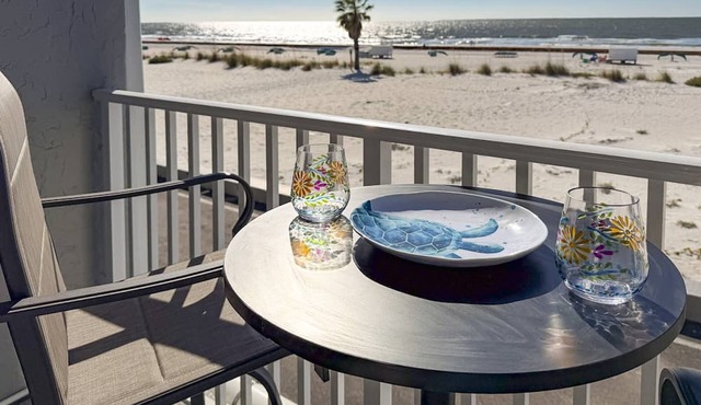Beachfront Balcony ~ View of Treasure Island Beach ~ Heated Pool, Tiki Bar, BBQ Grills, Volleyball.